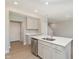 Bright kitchen featuring an island with a stainless steel dishwasher and a view of the stairway at 9652 Beckett St, Avon, IN 46123