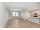 Spacious living room with luxury vinyl plank flooring, large windows, and a stylish sliding barn door at 9652 Beckett St, Avon, IN 46123