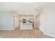 Open-concept living space with sleek LVP flooring, and a view of the modern kitchen and island at 9652 Beckett St, Avon, IN 46123