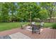 Charming backyard with a wooden deck, seating area, and lush greenery at 9885 Oakleaf Way, McCordsville, IN 46055
