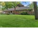Lush backyard with a brick home and patio, offering an inviting space for outdoor enjoyment and entertaining at 9885 Oakleaf Way, McCordsville, IN 46055