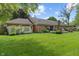 Expansive backyard with a brick home, patio, and well-manicured lawn at 9885 Oakleaf Way, McCordsville, IN 46055