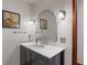 Elegant bathroom with a black vanity, white countertop, and arched mirror at 9885 Oakleaf Way, McCordsville, IN 46055
