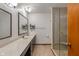 Bathroom featuring double sinks, a modern shower, and neutral tones, offering style and functionality at 9885 Oakleaf Way, McCordsville, IN 46055