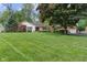 Charming single-story home with a brick facade, well-manicured lawn, and mature trees at 9885 Oakleaf Way, McCordsville, IN 46055