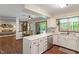 Open kitchen with white cabinets and a view of the living and dining areas, promoting connectivity at 9885 Oakleaf Way, McCordsville, IN 46055