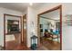 Cozy living room with wood floors, doorways to other rooms, and natural light at 9885 Oakleaf Way, McCordsville, IN 46055