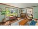 Bright living room featuring hardwood floors, a large window, and stylish mid-century modern furniture at 9885 Oakleaf Way, McCordsville, IN 46055