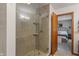 Modern tiled shower with glass door, complemented by neutral-toned walls, offering a spa-like experience at 9885 Oakleaf Way, McCordsville, IN 46055