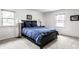 Cozy bedroom with neutral walls, carpet, and a dark wood bed frame at 100 Wellington Rd, Indianapolis, IN 46260
