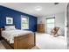 Comfortable bedroom with hardwood furnishings and a blue accent wall at 100 Wellington Rd, Indianapolis, IN 46260
