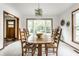 Bright dining room with a wood table, chairs, and an open view into the entryway and backyard at 100 Wellington Rd, Indianapolis, IN 46260