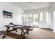 Bright sunroom with a picnic table that is set for a meal at 100 Wellington Rd, Indianapolis, IN 46260