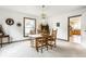 Cozy dining room featuring a round wood table, six chairs, light fixture, and view into the kitchen at 100 Wellington Rd, Indianapolis, IN 46260