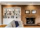 Living room brick fireplace with built-in shelving, decorated with books, vases, and framed artwork at 100 Wellington Rd, Indianapolis, IN 46260
