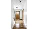 Clean foyer featuring hardwood floors, white walls, wooden accents, and a staircase leading to the upper level at 100 Wellington Rd, Indianapolis, IN 46260