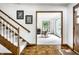 The home's foyer leads into a living room with hardwood floors and lots of natural light shining through the windows at 100 Wellington Rd, Indianapolis, IN 46260