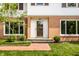 Attractive front entrance with brick accents, large windows, and a glass front door, complemented by lush landscaping at 100 Wellington Rd, Indianapolis, IN 46260