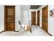 Bright hallway with multiple wooden doors, carpeted floor and access to stairs at 100 Wellington Rd, Indianapolis, IN 46260