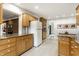 Kitchen with plenty of wood cabinets, light countertops, and a view to a sunlit nook at 100 Wellington Rd, Indianapolis, IN 46260