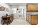 Cozy kitchen nook, wood table, and view to door and kitchen with wood cabinets at 100 Wellington Rd, Indianapolis, IN 46260