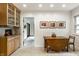 Cozy breakfast nook, wood table, and view into the kitchen with natural wood cabinets at 100 Wellington Rd, Indianapolis, IN 46260
