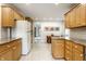 Kitchen with ample cabinet space, light countertops, and a view to a dining nook at 100 Wellington Rd, Indianapolis, IN 46260