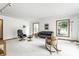 Spacious living room featuring neutral walls, plush carpet, track lighting, and comfortable seating for relaxing at 100 Wellington Rd, Indianapolis, IN 46260