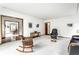 Bright living room with neutral walls, wood accents, rocking chair, and a large black leather chair at 100 Wellington Rd, Indianapolis, IN 46260