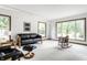 Sun-filled living room featuring neutral walls, plush carpet, track lighting, and comfortable seating at 100 Wellington Rd, Indianapolis, IN 46260