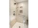 Close-up of the glass-enclosed shower with multiple shower heads and handrails at 100 Wellington Rd, Indianapolis, IN 46260
