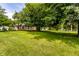 Expansive lawn with mature trees and a view of the house at 100 Wellington Rd, Indianapolis, IN 46260