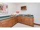 Basement wet bar with wooden cabinetry, popcorn machine, and a wine rack for entertainment at 10350 Courageous Dr, Indianapolis, IN 46236