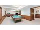 Finished basement with a pool table, wood paneled walls, and a separate seating area at 10350 Courageous Dr, Indianapolis, IN 46236