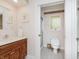 A bathroom features a sink vanity, a toilet, and a partially visible shower at 10350 Courageous Dr, Indianapolis, IN 46236