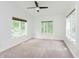A well-lit bedroom with wall-to-wall carpet, white walls, and windows at 10350 Courageous Dr, Indianapolis, IN 46236