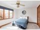 A cozy bedroom with a blue bedspread, window with blinds, and Colts team logo on the wall at 10350 Courageous Dr, Indianapolis, IN 46236