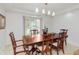 Dining room with hardwood table and chairs and bright natural light at 10350 Courageous Dr, Indianapolis, IN 46236