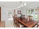 Dining room with hardwood table and chairs and view of a living room at 10350 Courageous Dr, Indianapolis, IN 46236