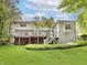 Exterior of the home showcasing a large deck and beautifully maintained lawn at 10350 Courageous Dr, Indianapolis, IN 46236