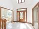 Bright foyer featuring tile floors, a decorative glass door, and staircase at 10350 Courageous Dr, Indianapolis, IN 46236
