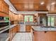 Kitchen with a granite countertop, wooden cabinets, stainless steel appliances, and a view of the backyard at 10350 Courageous Dr, Indianapolis, IN 46236