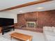Inviting living room area featuring a large brick fireplace and comfortable sofas at 10350 Courageous Dr, Indianapolis, IN 46236