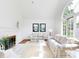 Bright living room featuring high ceilings, a fireplace, and large arched window at 10350 Courageous Dr, Indianapolis, IN 46236