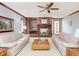 Cozy living room with a brick fireplace and mantle, and plush sofas at 10350 Courageous Dr, Indianapolis, IN 46236