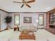 Inviting living room with a brick fireplace and a light-colored sofa set under a wooden ceiling fan at 10350 Courageous Dr, Indianapolis, IN 46236