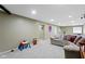 Finished basement features an entertainment area with sofa and ' play area for Gathering enjoyment at 11872 Traymoore Dr, Fishers, IN 46038