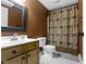 Bathroom with decorative shower curtain, a framed mirror, and vanity with storage underneath at 11872 Traymoore Dr, Fishers, IN 46038