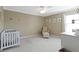 Neutral Bedroom features a white crib, comfortable chair and ottoman, and cheerful animal art at 11872 Traymoore Dr, Fishers, IN 46038