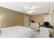 Neutral bedroom with a ceiling fan, a work space, and ample storage space in the built in dresser and closet at 11872 Traymoore Dr, Fishers, IN 46038